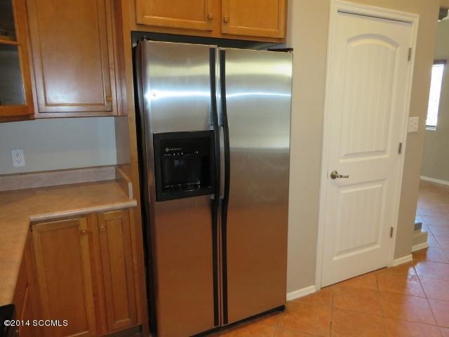 330 Ambrosia Court Rio Rico, AZ 85648 - Photo 17 of 37 a view of a refrigerator in kitchen and a glass door