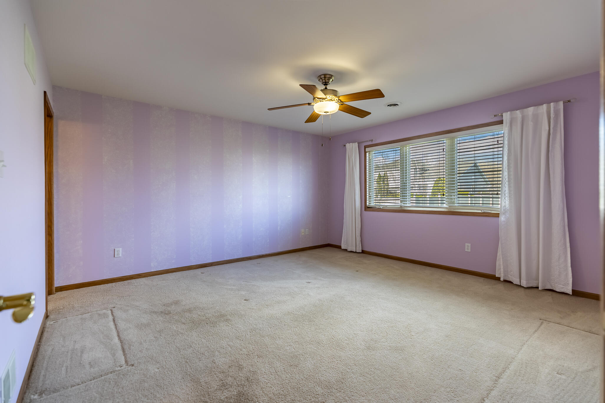 9841 Hart Street St. John, IN 46373 - Photo 11 of 28 an empty room with windows and chandelier fan