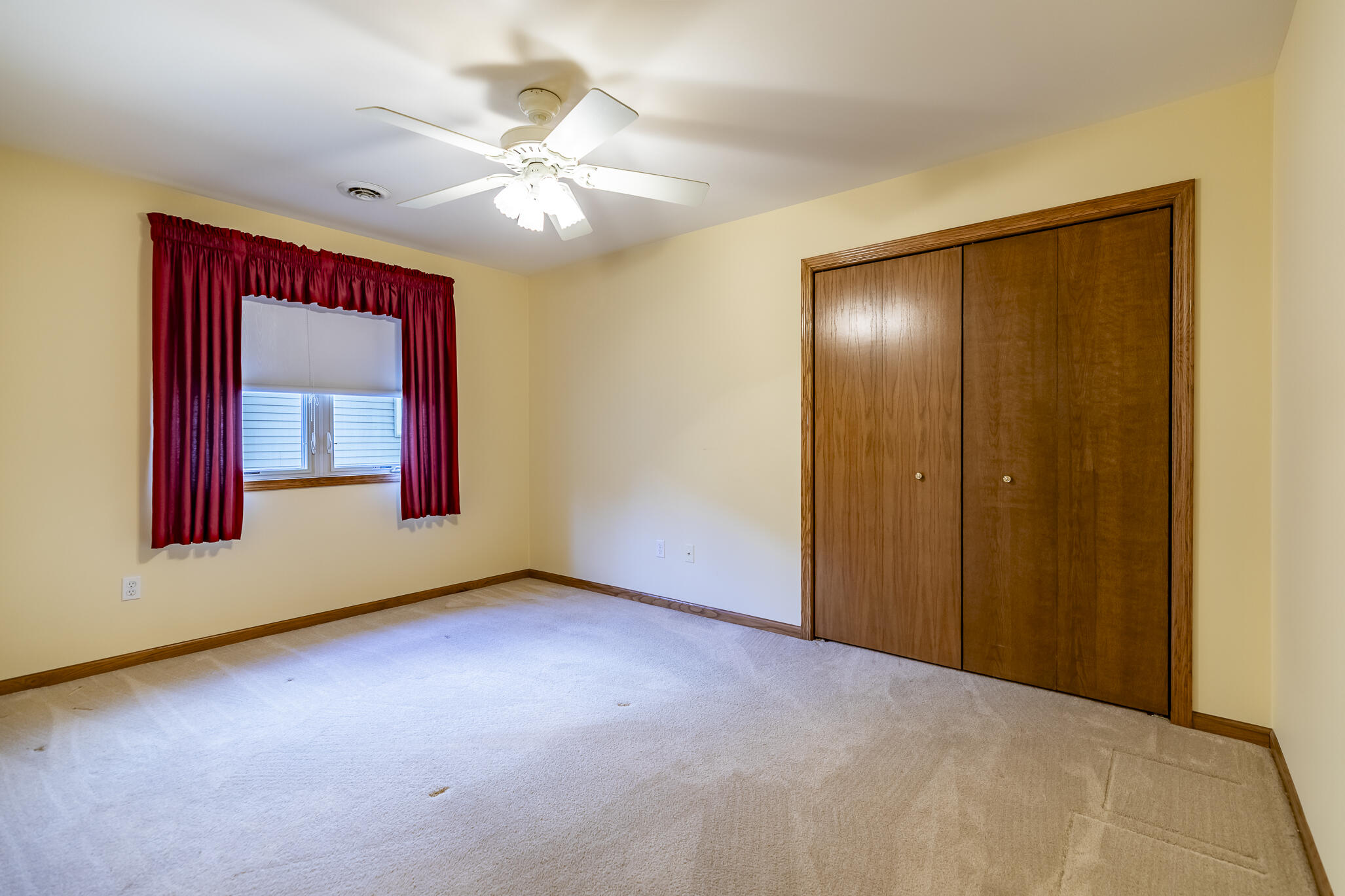 9841 Hart Street St. John, IN 46373 - Photo 18 of 28 a view of an empty room with window and chandelier fan