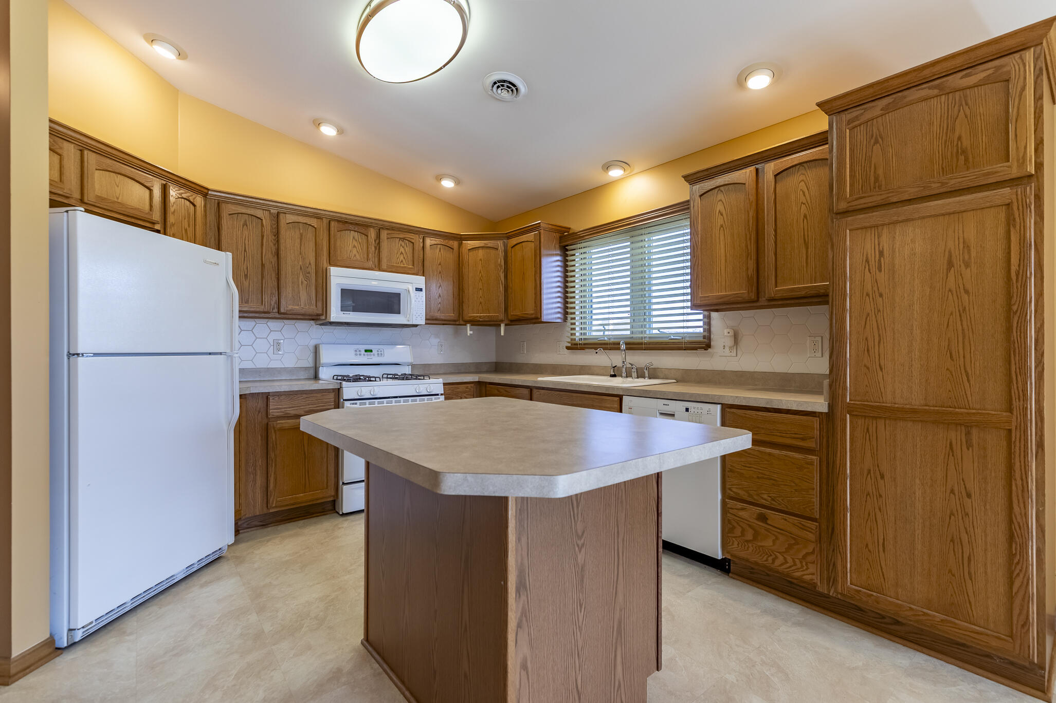 9841 Hart Street St. John, IN 46373 - Photo 7 of 28 a kitchen with stainless steel appliances granite countertop a refrigerator a sink dishwasher a stove with a refrigerator and a stove