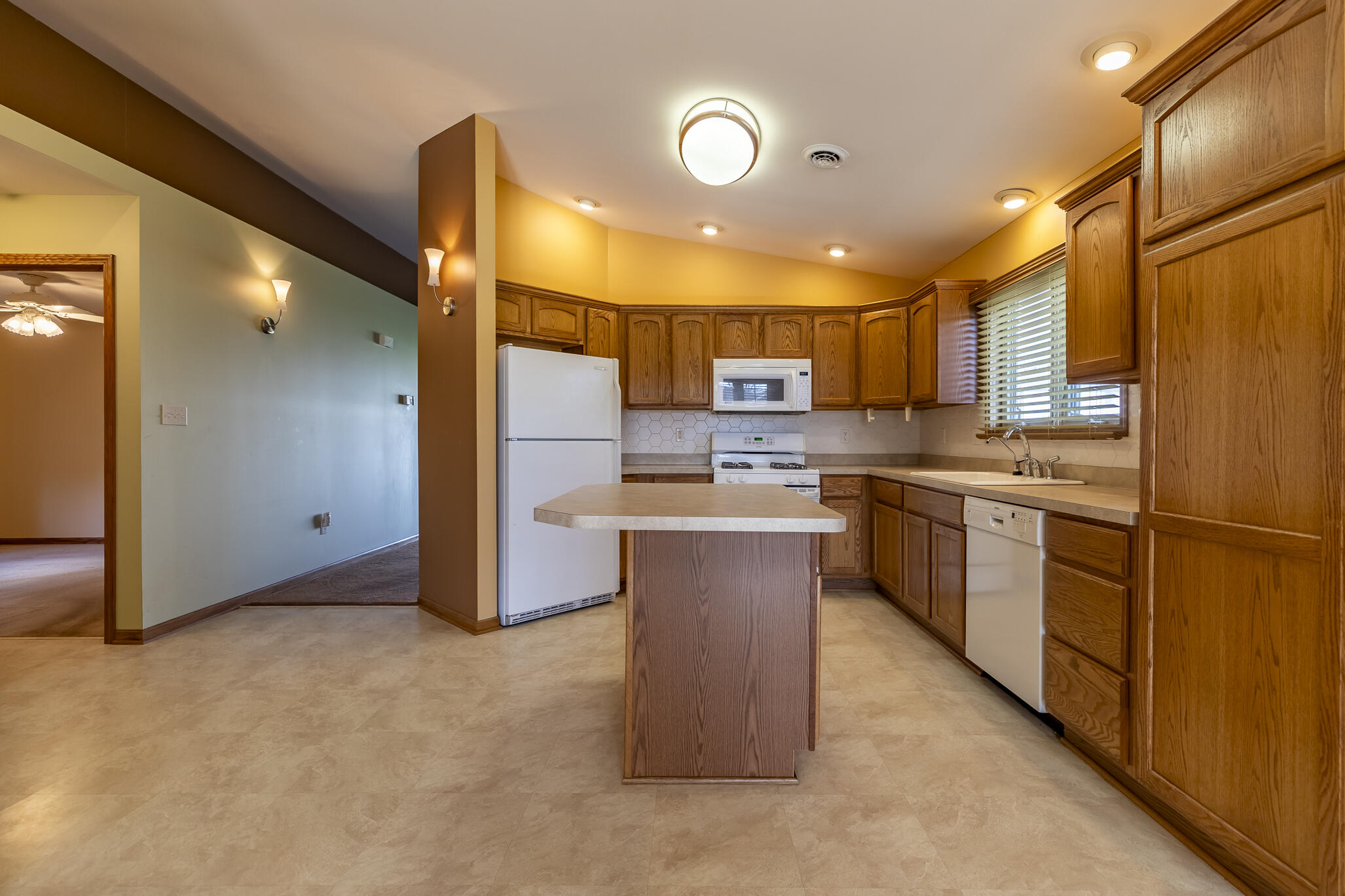9841 Hart Street St. John, IN 46373 - Photo 8 of 28 a kitchen with stainless steel appliances granite countertop a refrigerator a stove and a sink