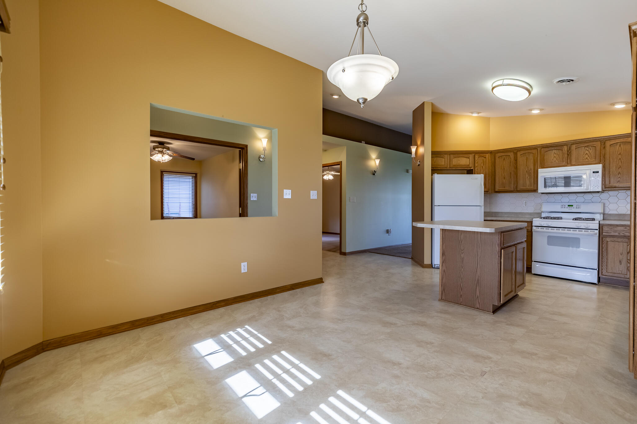 9841 Hart Street St. John, IN 46373 - Photo 9 of 28 a kitchen with stainless steel appliances granite countertop a sink and a refrigerator