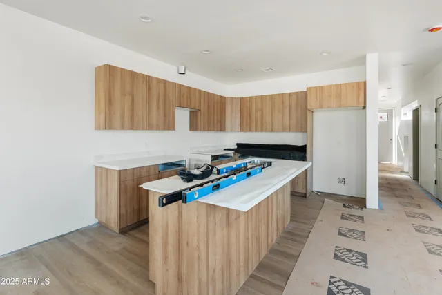 a kitchen with a sink a stove and a refrigerator
