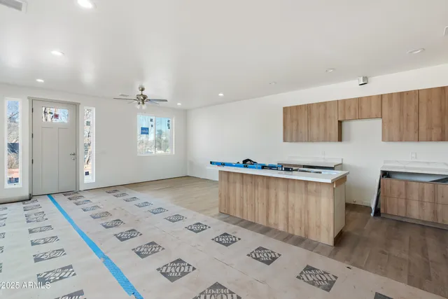 a living room with a bed furniture and a wooden floor