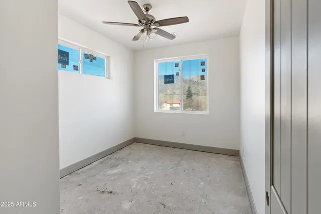 a view of room with window and ceiling fan