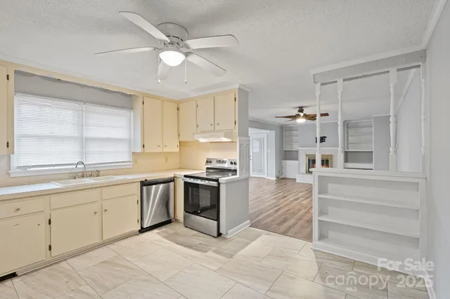 a kitchen with a stove a sink and a refrigerator