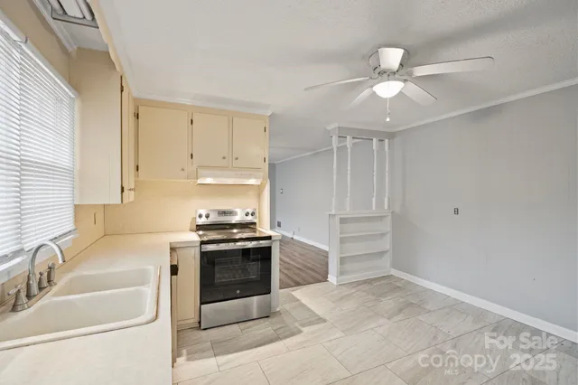 a view of a kitchen with a sink and refrigerator