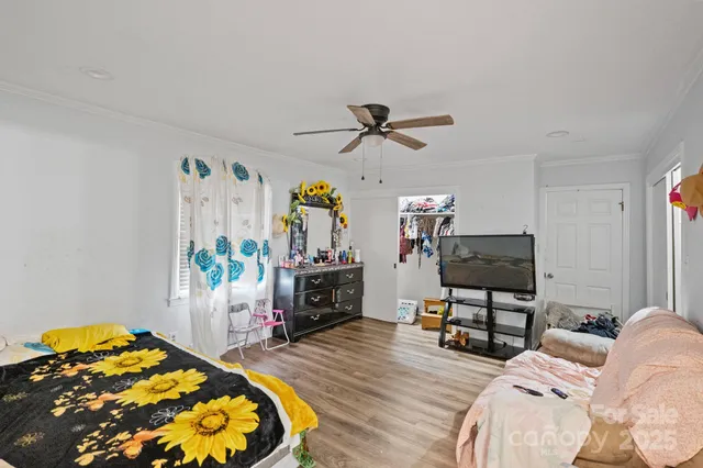 a view of a patio with a table and chairs and wooden fence
