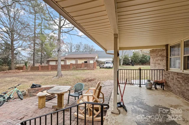 a view of a house with a yard covered in snow