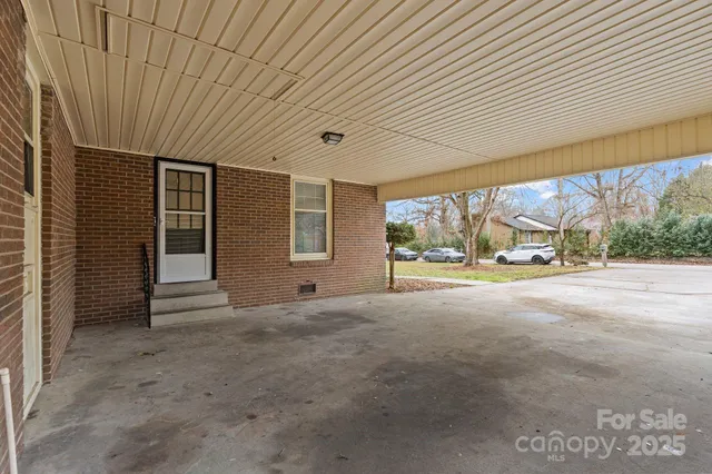 an aerial view of a house with a yard and a large tree