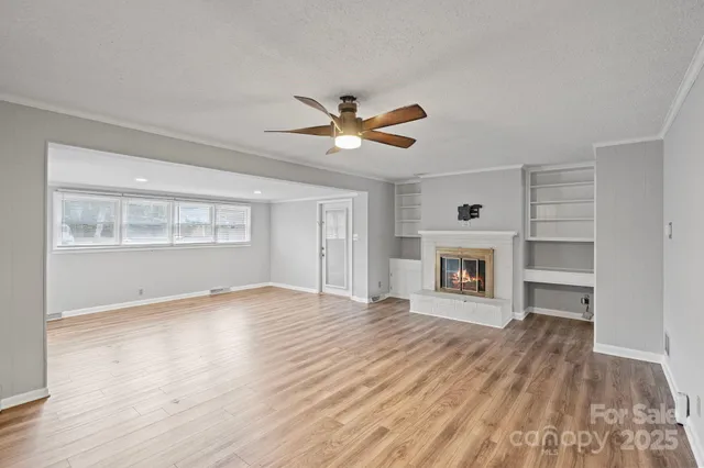 wooden floor in an empty room with a fireplace