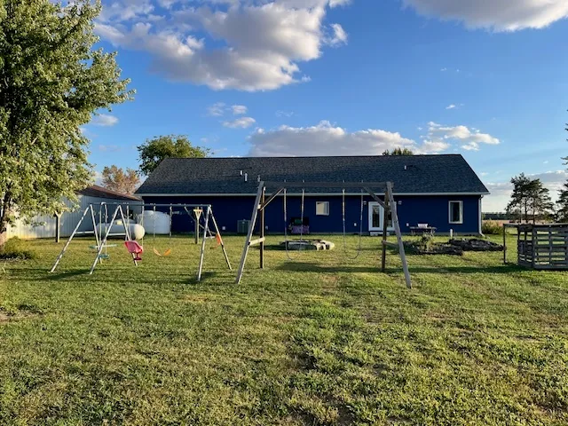 a swimming pool with outdoor seating and yard