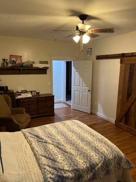 466 County Road 100 North Sadorus, IL 61872 - Photo 14 of 29 a spacious bedroom with a bed and wooden floor