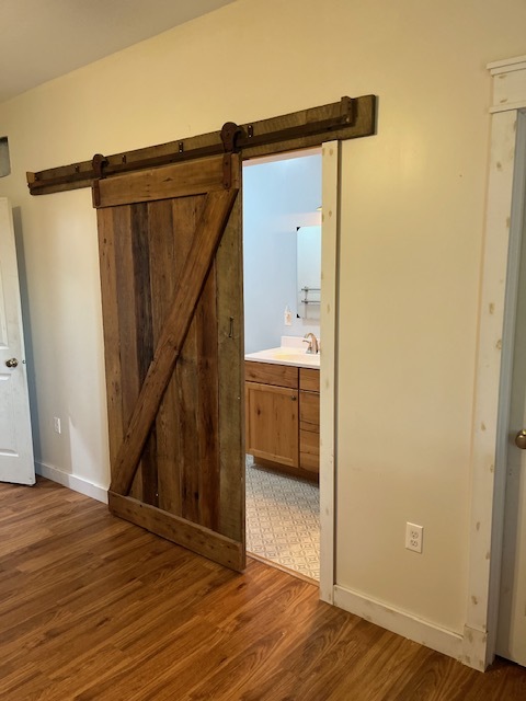 466 County Road 100 North Sadorus, IL 61872 - Photo 16 of 29 a view of a hallway with wooden floor and staircase