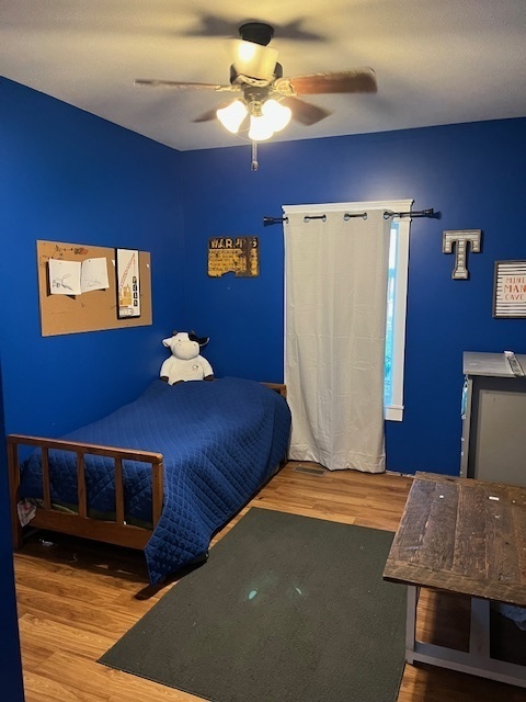 466 County Road 100 North Sadorus, IL 61872 - Photo 23 of 29 a bedroom with a bed and a ceiling fan