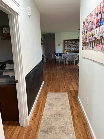 a hallway with chairs and wooden floor