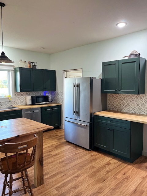 466 County Road 100 North Sadorus, IL 61872 - Photo 7 of 29 a kitchen with stainless steel appliances kitchen island granite countertop a refrigerator stove and oven with wooden floor