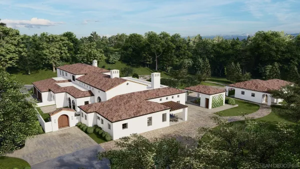 an aerial view of a house with swimming pool and garden