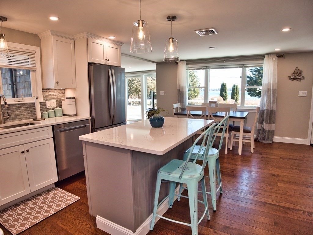 3 East Shore Road Westport, MA 02791 - Photo 11 of 21 a kitchen with stainless steel appliances granite countertop a dining table chairs refrigerator sink and stove