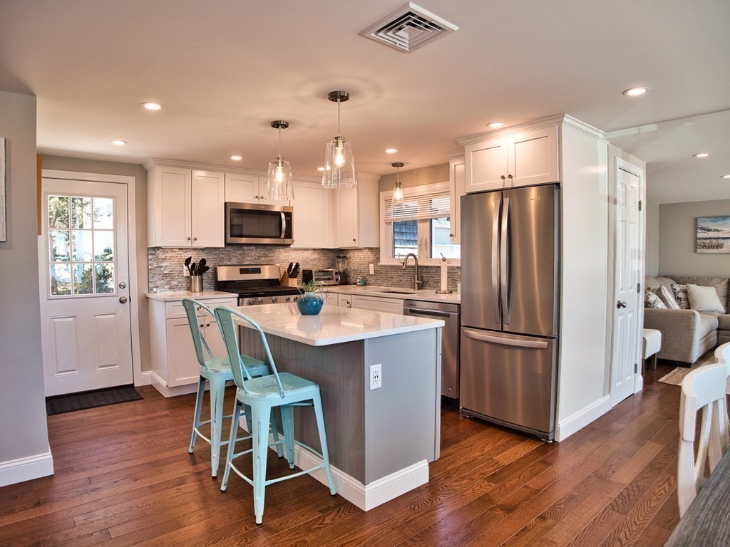 3 East Shore Road Westport, MA 02791 - Photo 12 of 21 a kitchen with kitchen island wooden floors white appliances and cabinets