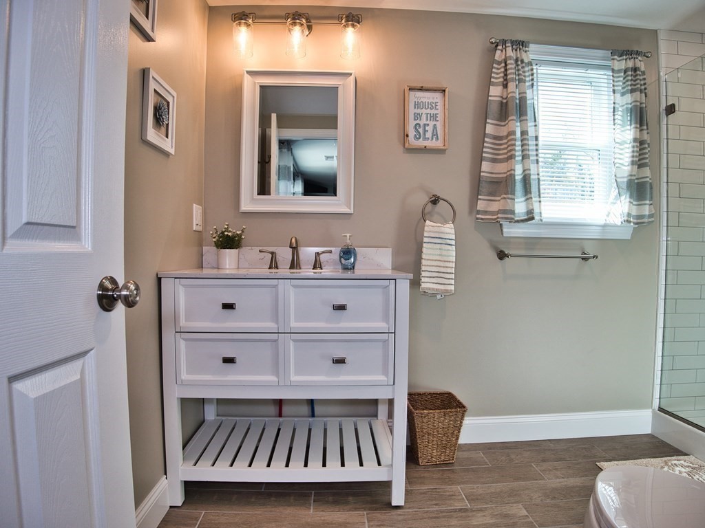 3 East Shore Road Westport, MA 02791 - Photo 15 of 21 a bathroom with a sink a toilet and mirror