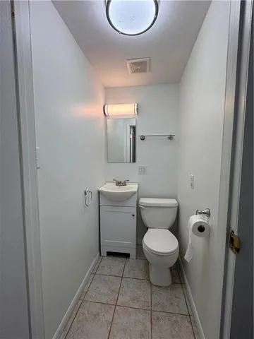 a front view of house with yard and trees in the background