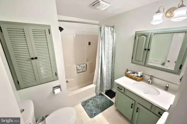 a bathroom with a tub sink and mirror