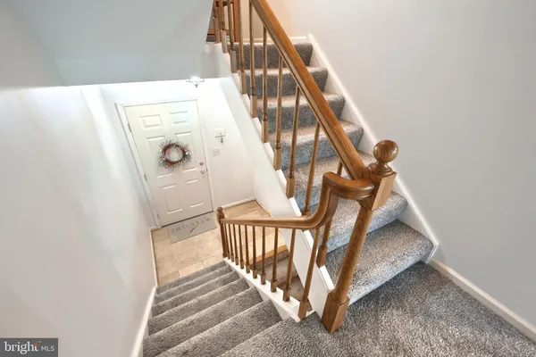 a view of staircase with white walls and a window