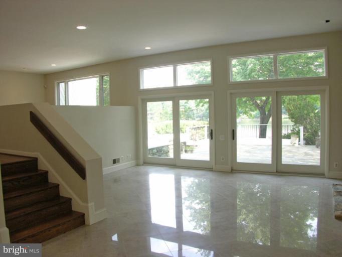 2204 Spinnaker Court Reston, VA 20191 - Photo 4 of 20 a view of an empty room with wooden floor and a window