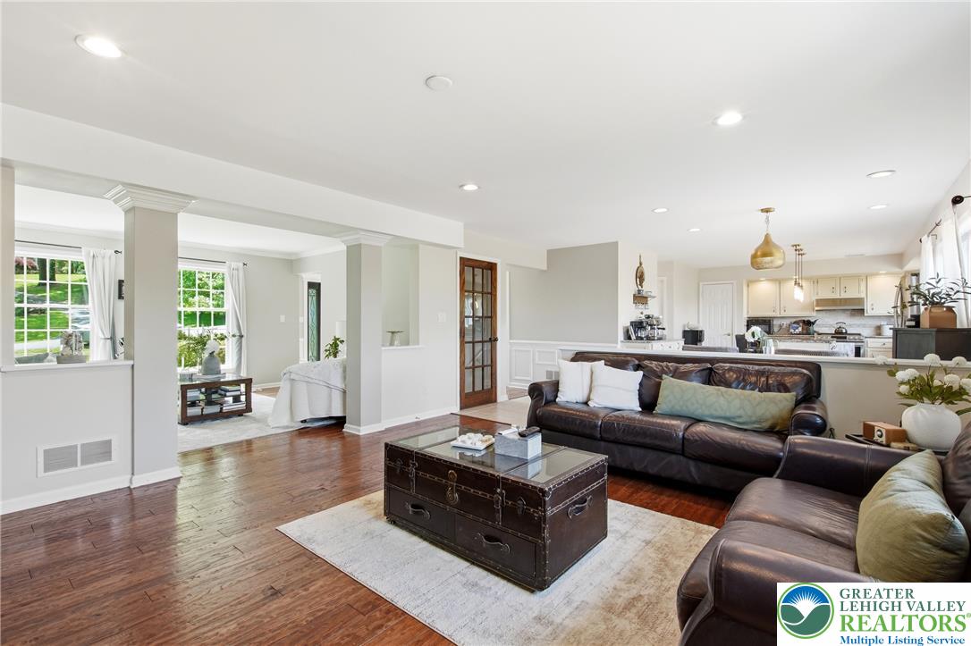 115 West Butternut Road Hellertown, PA 18055 - Photo 27 of 97 Hardwood floors and recessed lighting grace this open-concept living area, seamlessly connecting to the kitchen.
