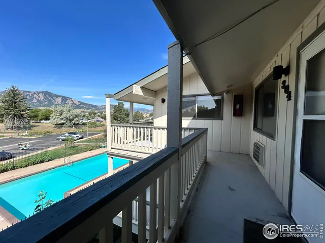a view of a balcony with two chairs and a table