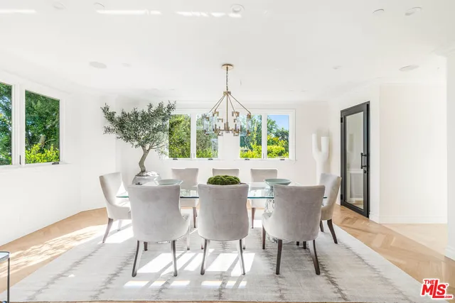a view of a dining room with furniture and chandelier