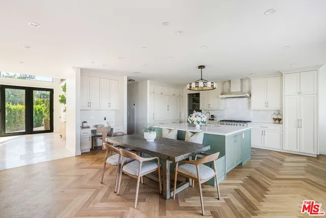 a kitchen with white cabinets and appliances