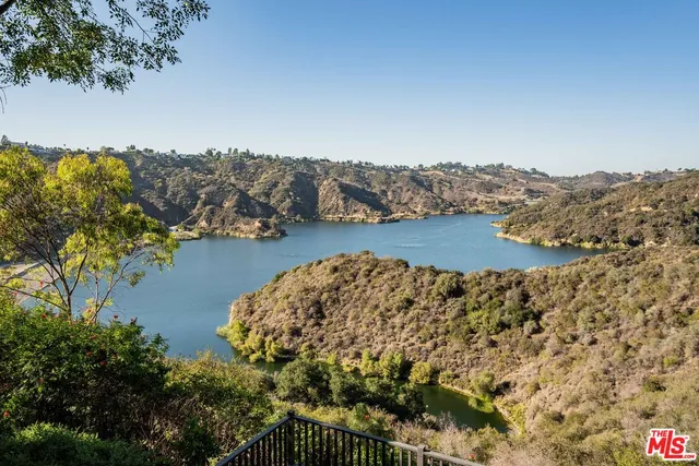 a view of swimming pool with chairs and garden