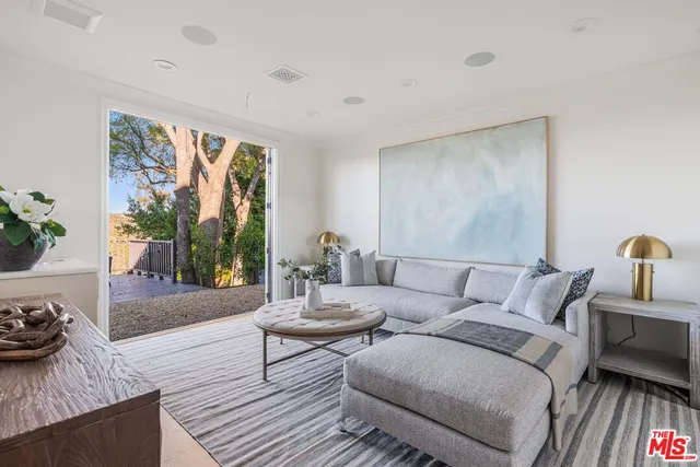 a living room with furniture a rug and a window