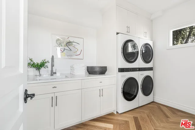 a balcony with wooden floor table and chairs