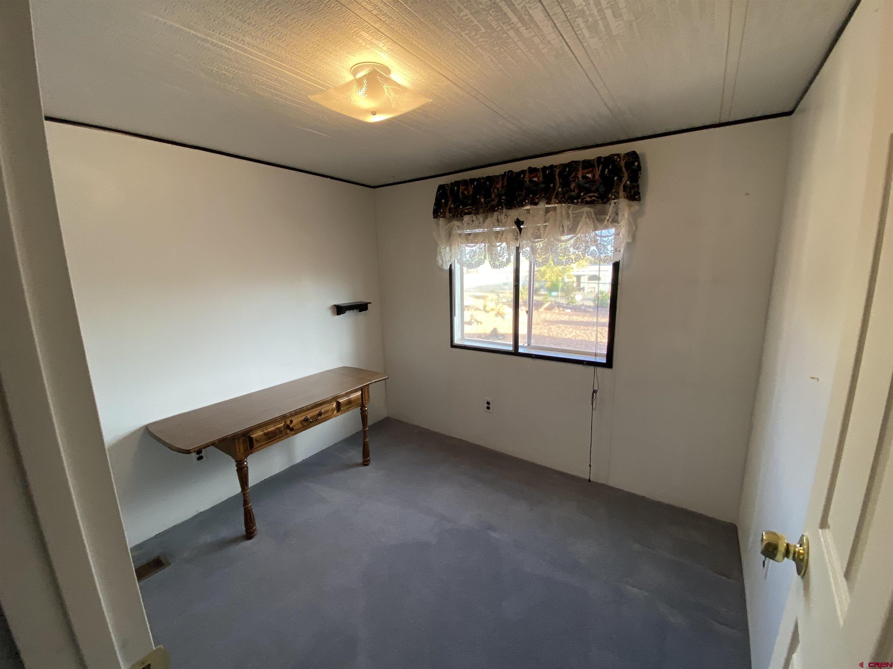 21159 Nowhere Road Eckert, CO 81418 - Photo 8 of 27 a view of an empty room with a window