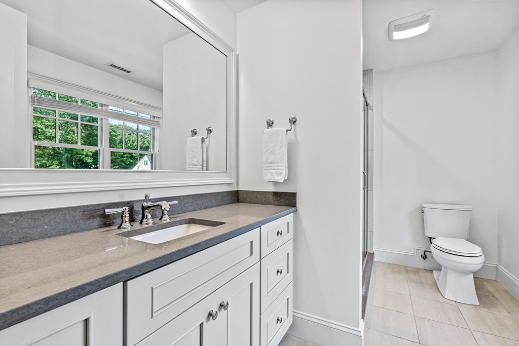 46 Pilgrim Road Wellesley, MA 02481 - Photo 18 of 35 a bathroom with a granite countertop sink a toilet and a mirror