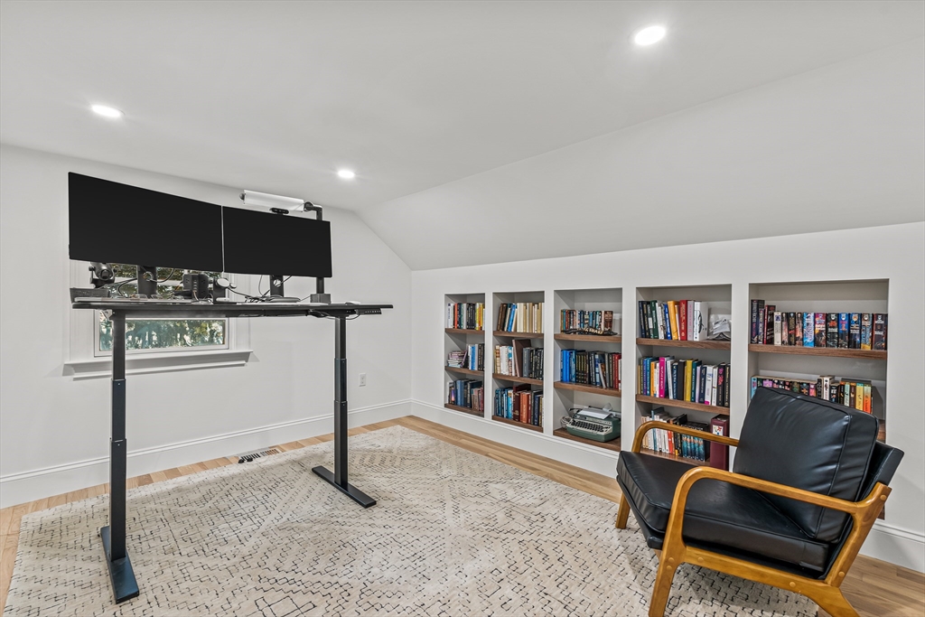 46 Pilgrim Road Wellesley, MA 02481 - Photo 24 of 35 a living room with furniture a flat screen tv and a book shelf