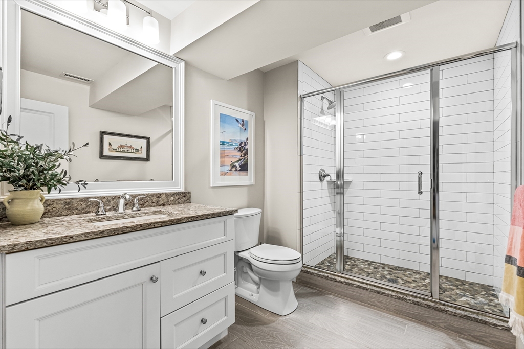 46 Pilgrim Road Wellesley, MA 02481 - Photo 28 of 35 a bathroom with a granite countertop sink toilet and shower