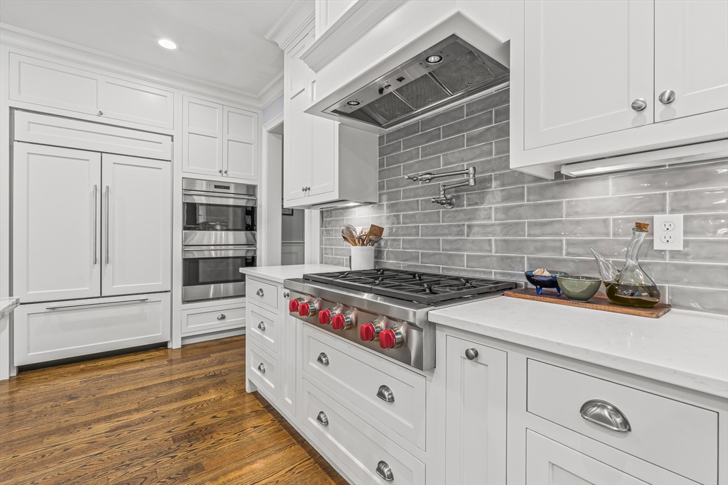46 Pilgrim Road Wellesley, MA 02481 - Photo 7 of 35 a kitchen with stainless steel appliances a stove and cabinets