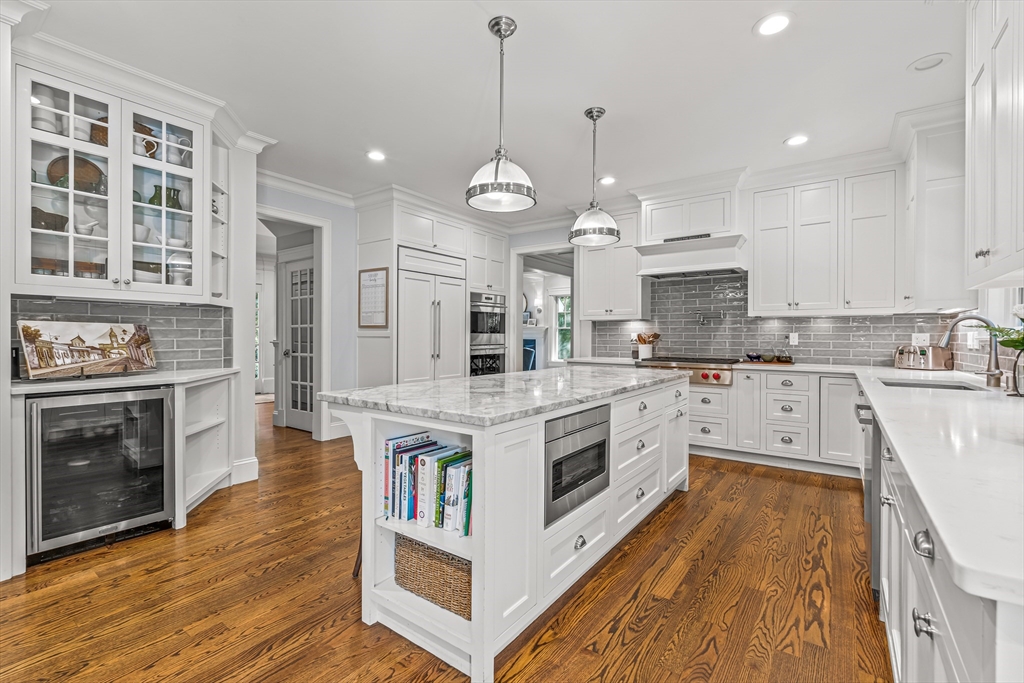 46 Pilgrim Road Wellesley, MA 02481 - Photo 8 of 35 a white kitchen with wooden floor and stainless steel appliances