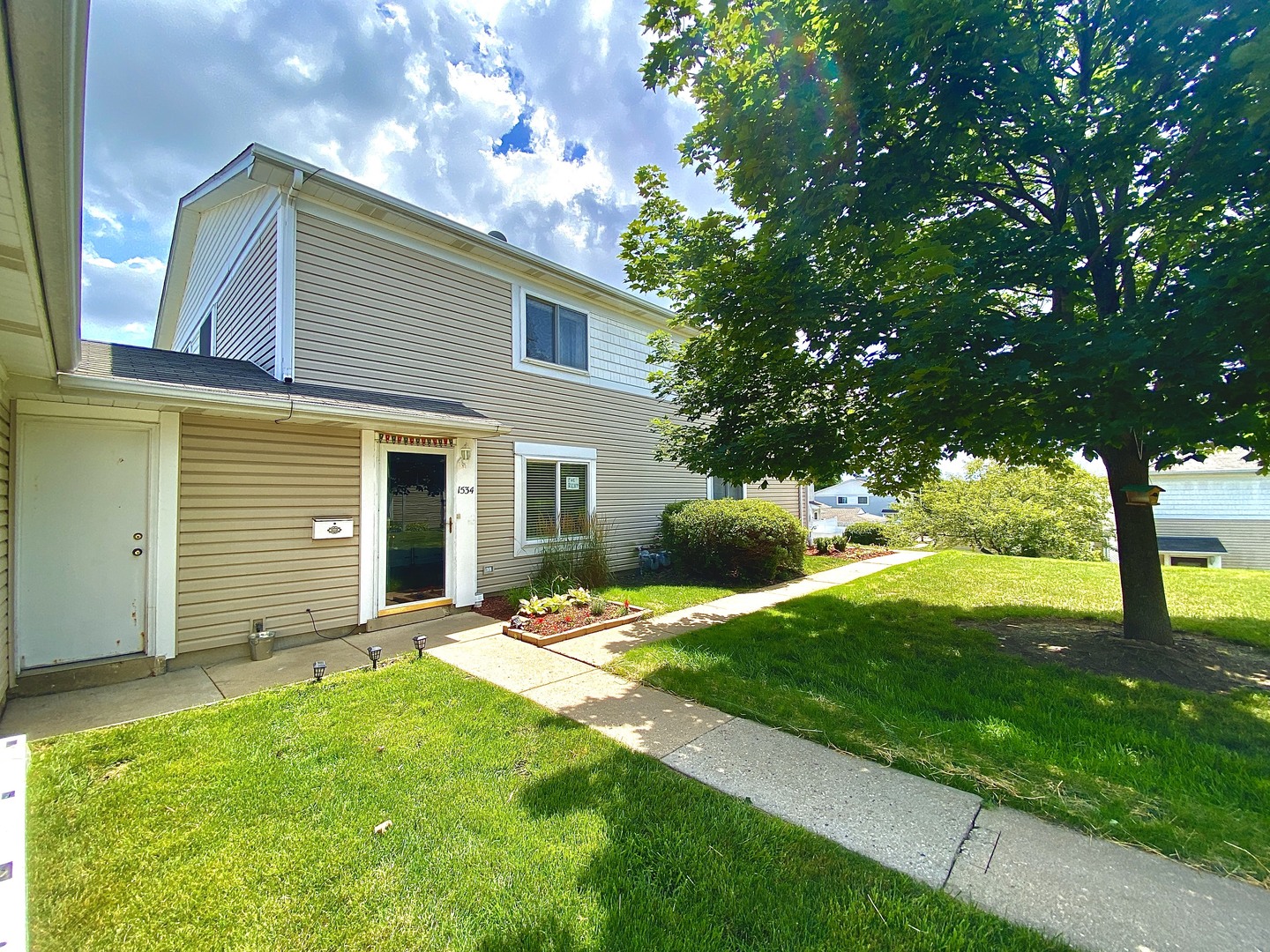 1534 Cornell Circle, Unit 34D Hoffman Estates, IL 60169 - Photo 1 of 15 a view of a house with backyard and a tree