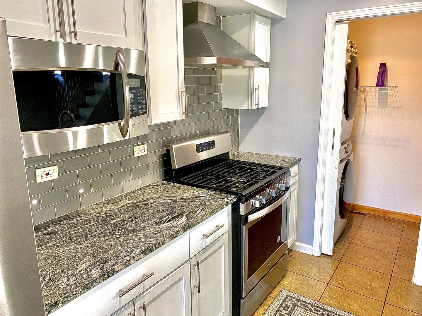 1534 Cornell Circle, Unit 34D Hoffman Estates, IL 60169 - Photo 5 of 15 a kitchen with stainless steel appliances granite countertop a stove and a microwave