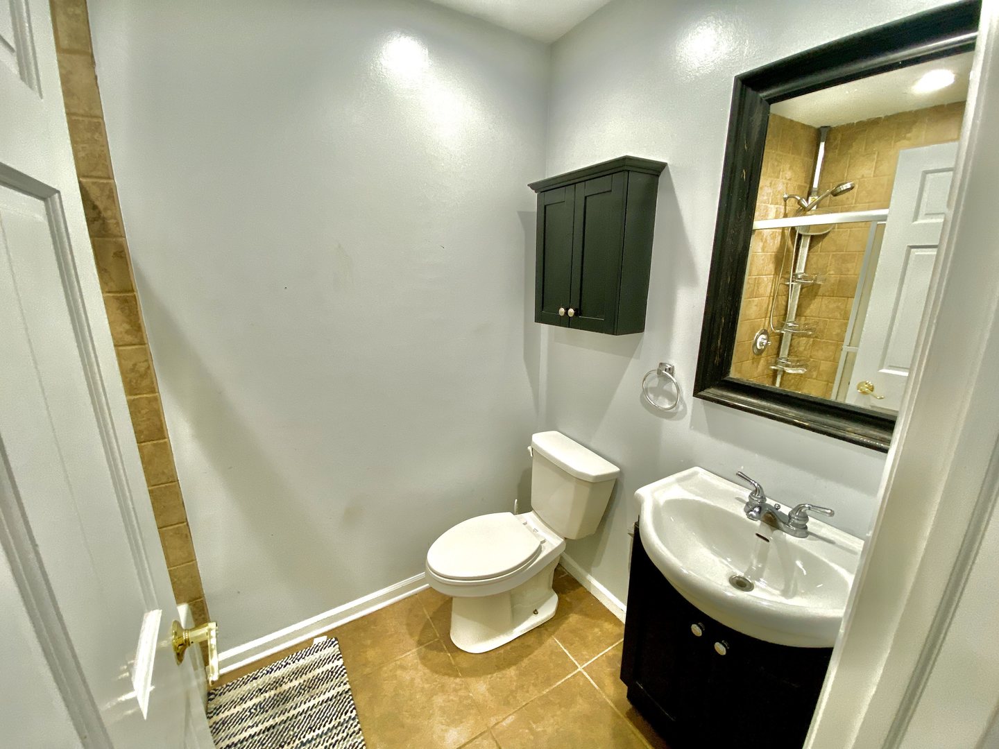 1534 Cornell Circle, Unit 34D Hoffman Estates, IL 60169 - Photo 9 of 15 a bathroom with a toilet sink and mirror