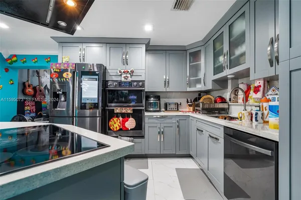 a kitchen with stainless steel appliances granite countertop a sink and cabinets