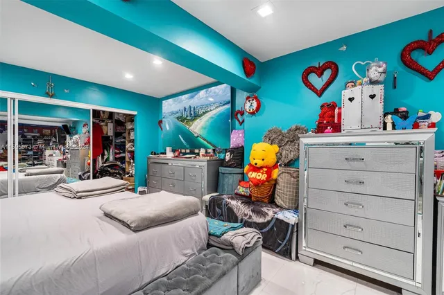 a bedroom with a baby bed baby crib and dresser