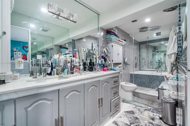 a bathroom with a toilet sink and mirror