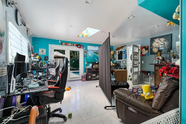 a view of a workspace with furniture and a flat screen tv