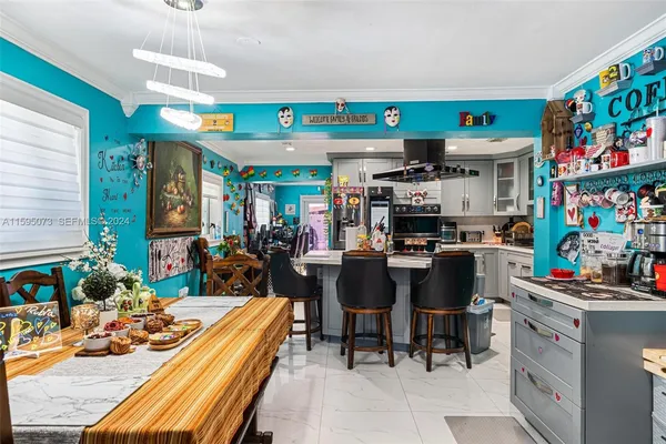 a room with stainless steel appliances lots of furniture and decor